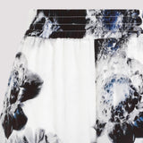 Close-up of Alexander McQueen pants hardware and fine stitching