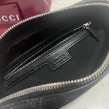 Gucci Pouch flat lay on neutral background