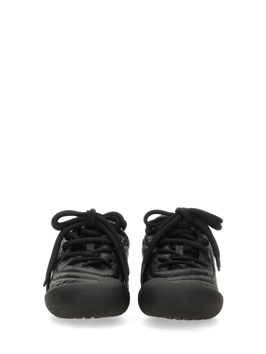 Close-up of Alexander McQueen athletic hardware and fine stitching