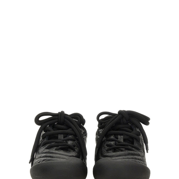 Close-up of Alexander McQueen athletic hardware and fine stitching