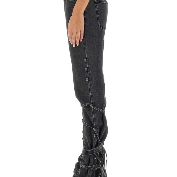 Close-up of Alexander McQueen pants hardware and fine stitching