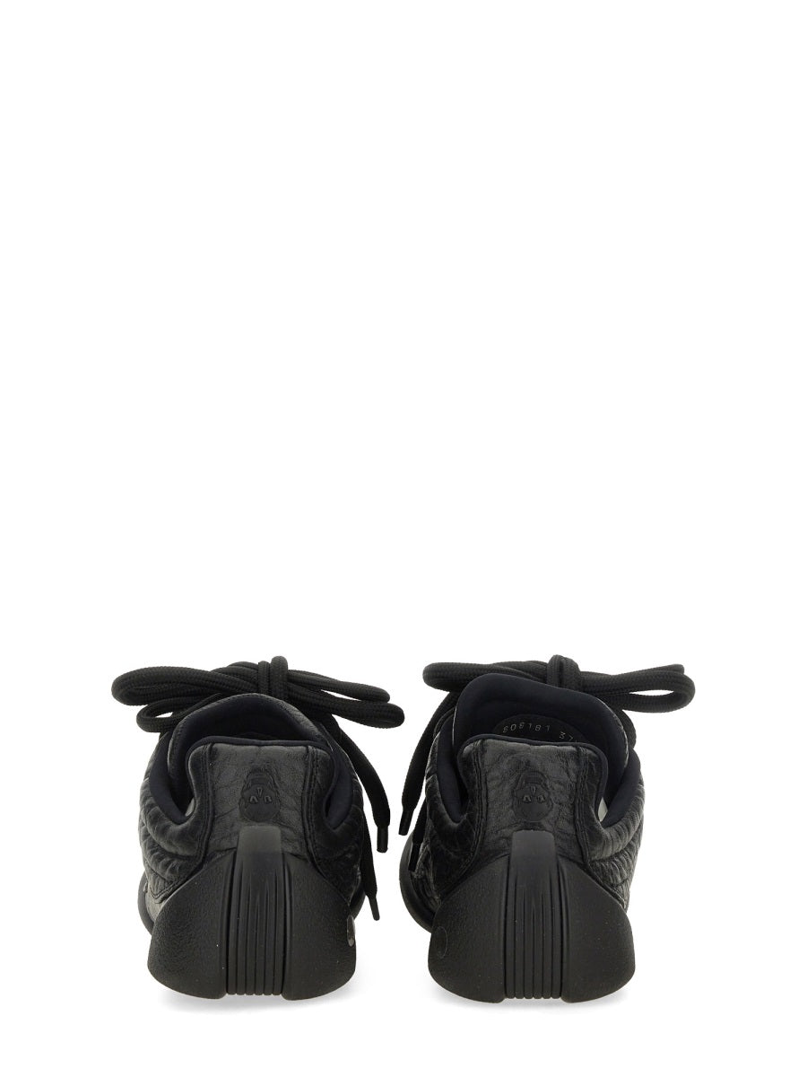 Close-up of Alexander McQueen athletic hardware and fine stitching