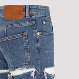 Close-up of Alexander McQueen pants hardware and fine stitching