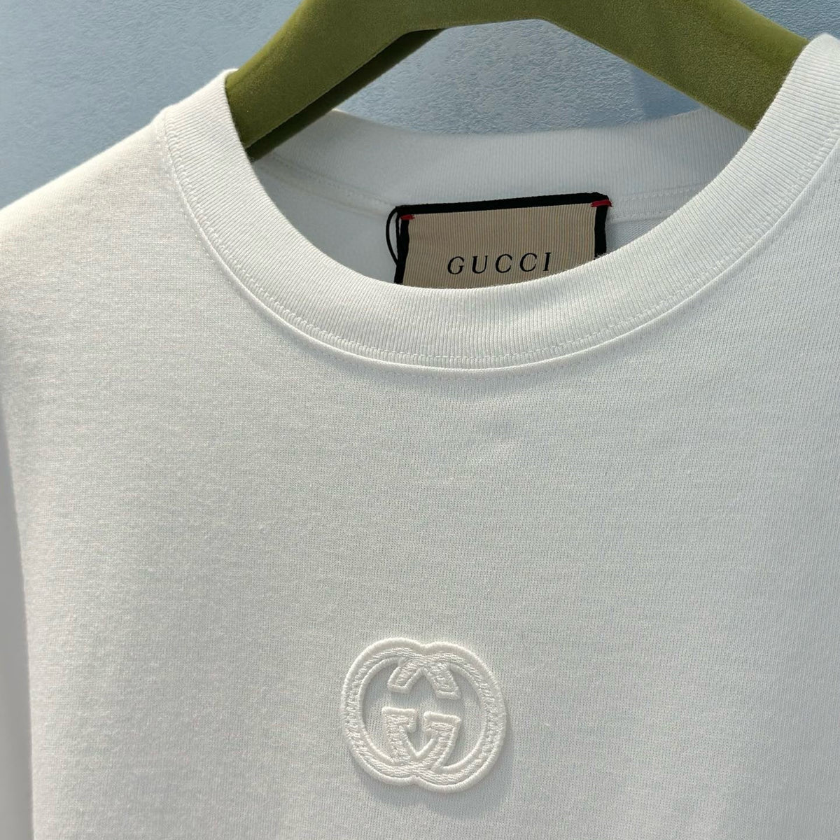 Close-up of Gucci T-Shirt signature hardware and stitching detail