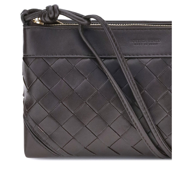 Close-up of Bottega Veneta clutches hardware and fine stitching
