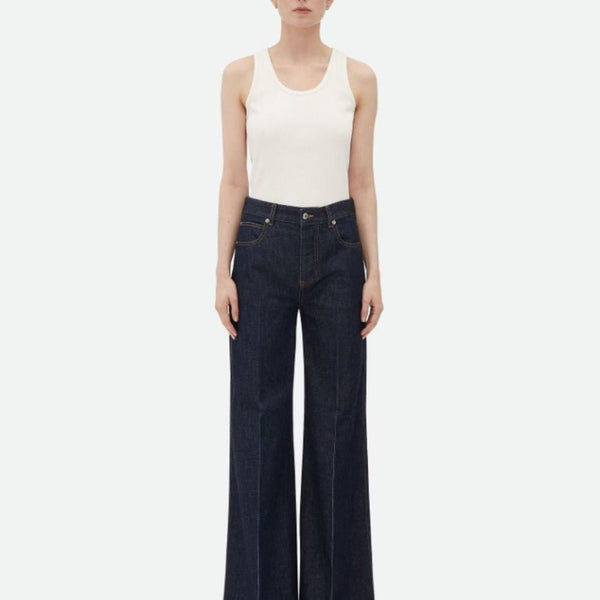 Close-up of Bottega Veneta pants hardware and fine stitching