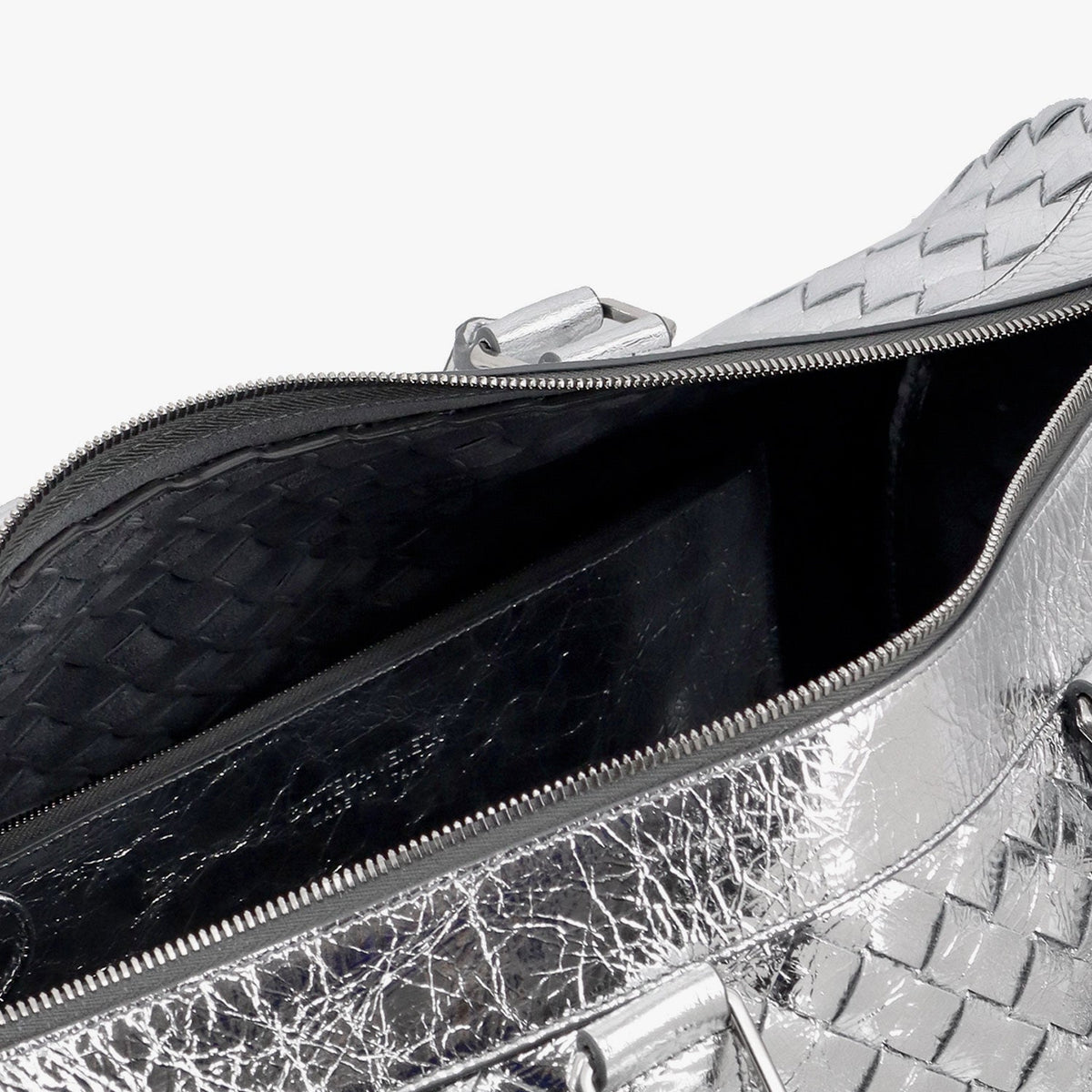 Close-up of Bottega Veneta travel and lugguage hardware and fine stitching
