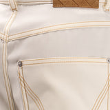 Close-up of Bottega Veneta pants hardware and fine stitching