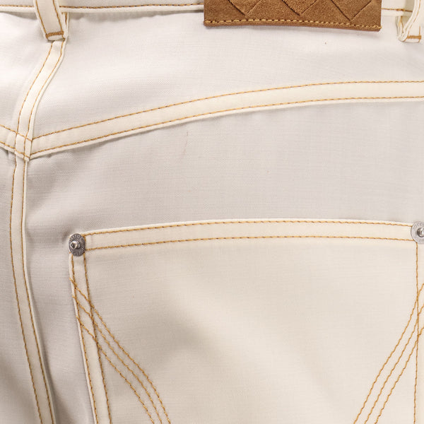 Close-up of Bottega Veneta pants hardware and fine stitching