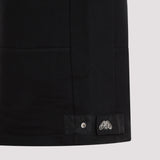 Close-up of Alexander McQueen pants hardware and fine stitching