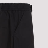 Close-up of Alexander McQueen pants hardware and fine stitching
