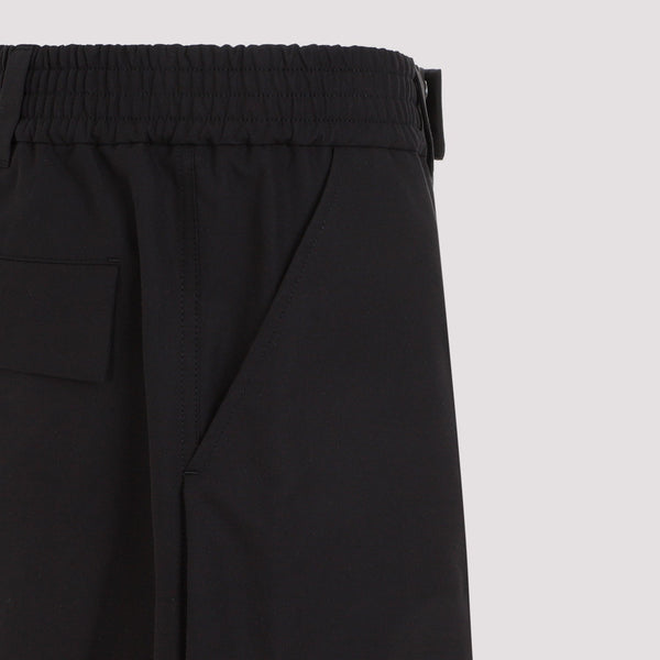 Close-up of Alexander McQueen pants hardware and fine stitching
