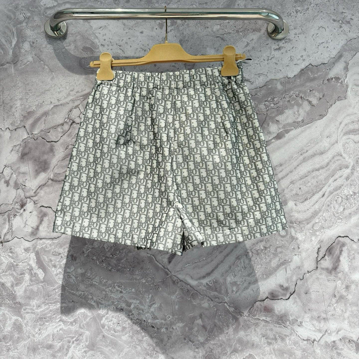 Christian Dior Shorts flat lay on neutral background