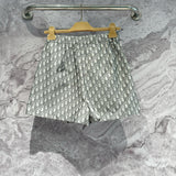 Christian Dior Shorts flat lay on neutral background