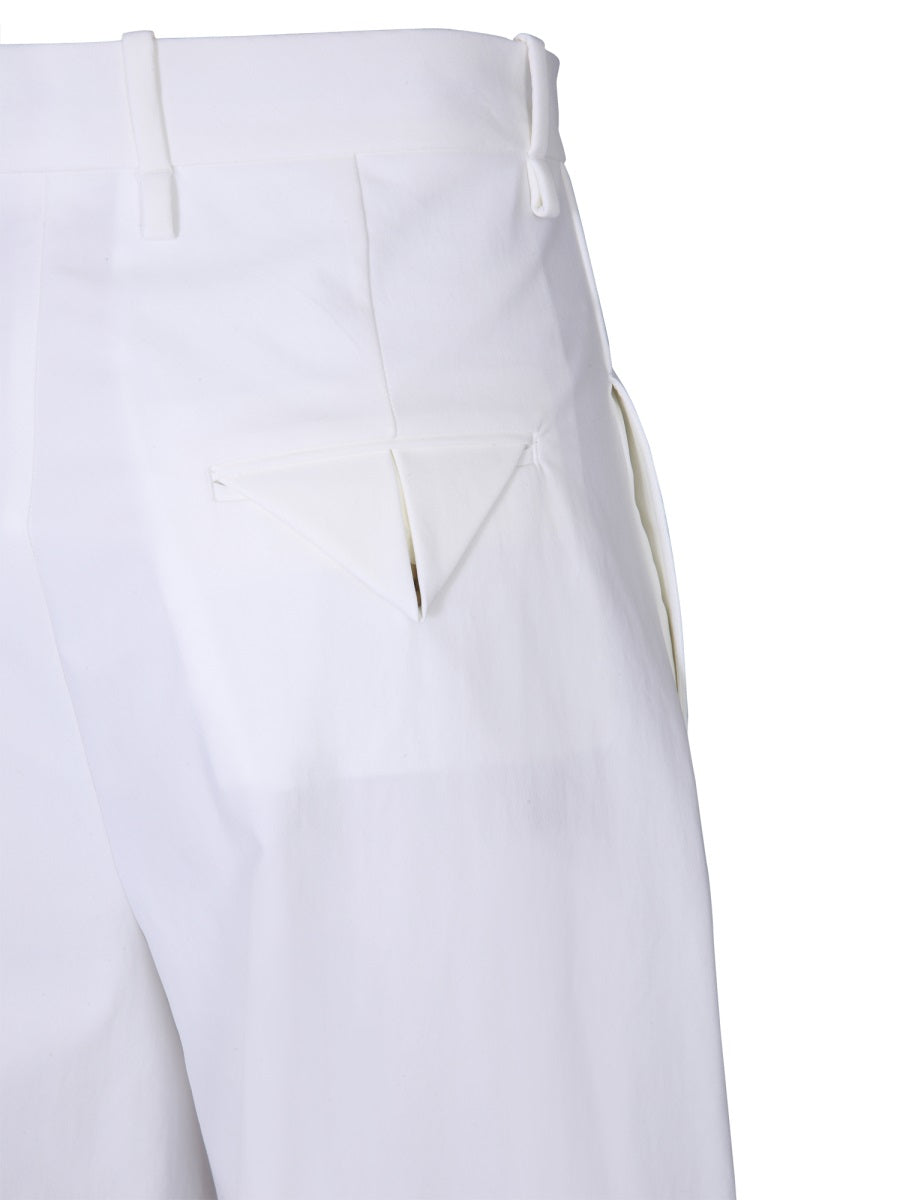 Close-up of Bottega Veneta pants hardware and fine stitching