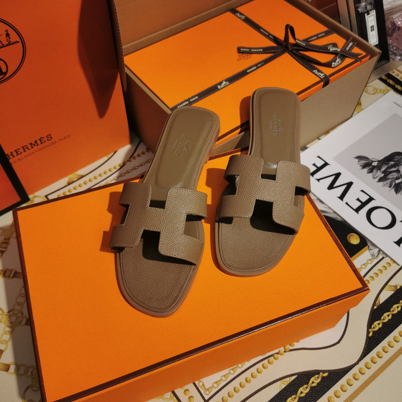 Hermès Black Flat Thong Sandals - Lifestyle Styling Shot