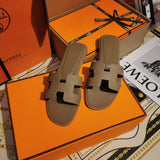 Hermès Black Flat Thong Sandals - Lifestyle Styling Shot