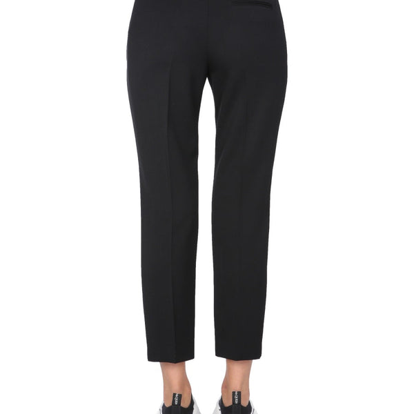 Close-up of Alexander McQueen pants hardware and fine stitching