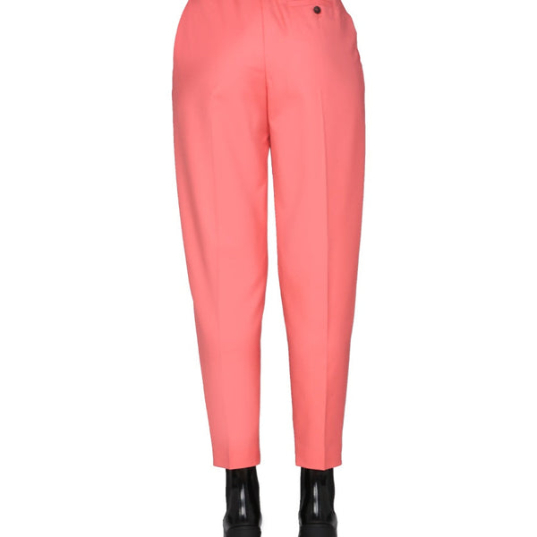 Close-up of Alexander McQueen pants hardware and fine stitching