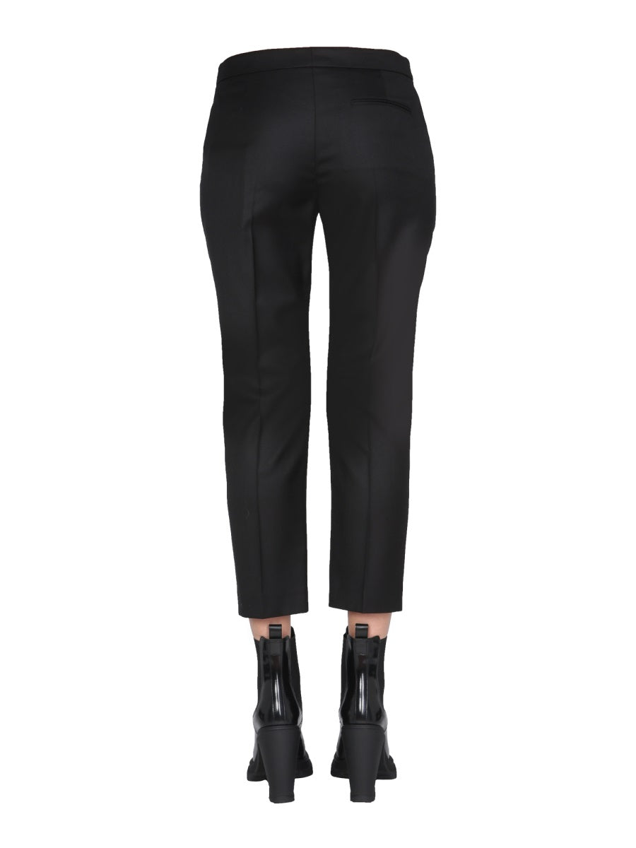 Close-up of Alexander McQueen pants hardware and fine stitching