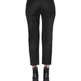 Close-up of Alexander McQueen pants hardware and fine stitching