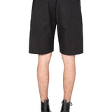 Close-up of Alexander McQueen pants hardware and fine stitching