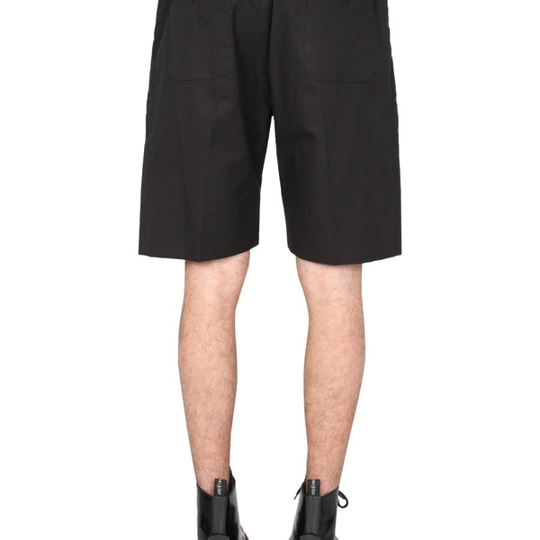 Close-up of Alexander McQueen pants hardware and fine stitching