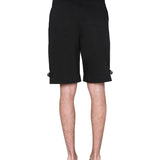 Close-up of Alexander McQueen pants hardware and fine stitching