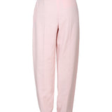Close-up of Alexander McQueen pants hardware and fine stitching