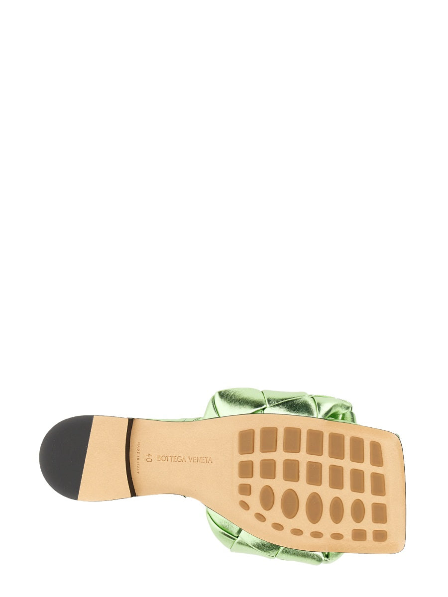 Close-up of Bottega Veneta sandals hardware and fine stitching