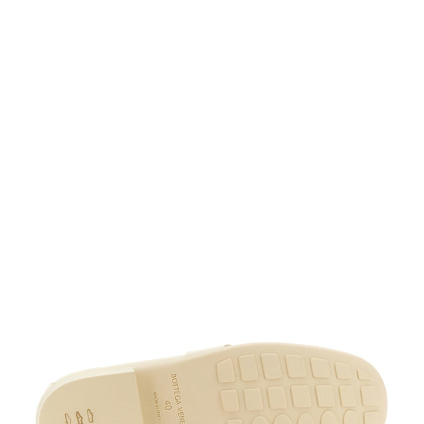 Close-up of Bottega Veneta slides hardware and fine stitching