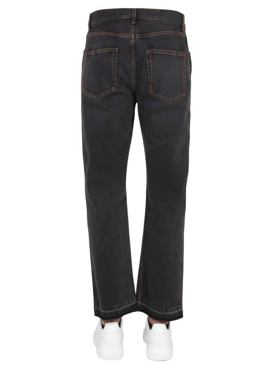 Close-up of Alexander McQueen pants hardware and fine stitching