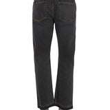 Close-up of Alexander McQueen pants hardware and fine stitching