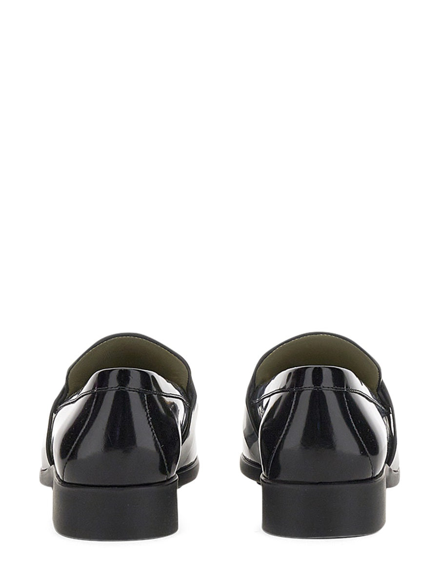 Close-up of Bottega Veneta slides hardware and fine stitching