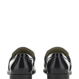 Close-up of Bottega Veneta slides hardware and fine stitching