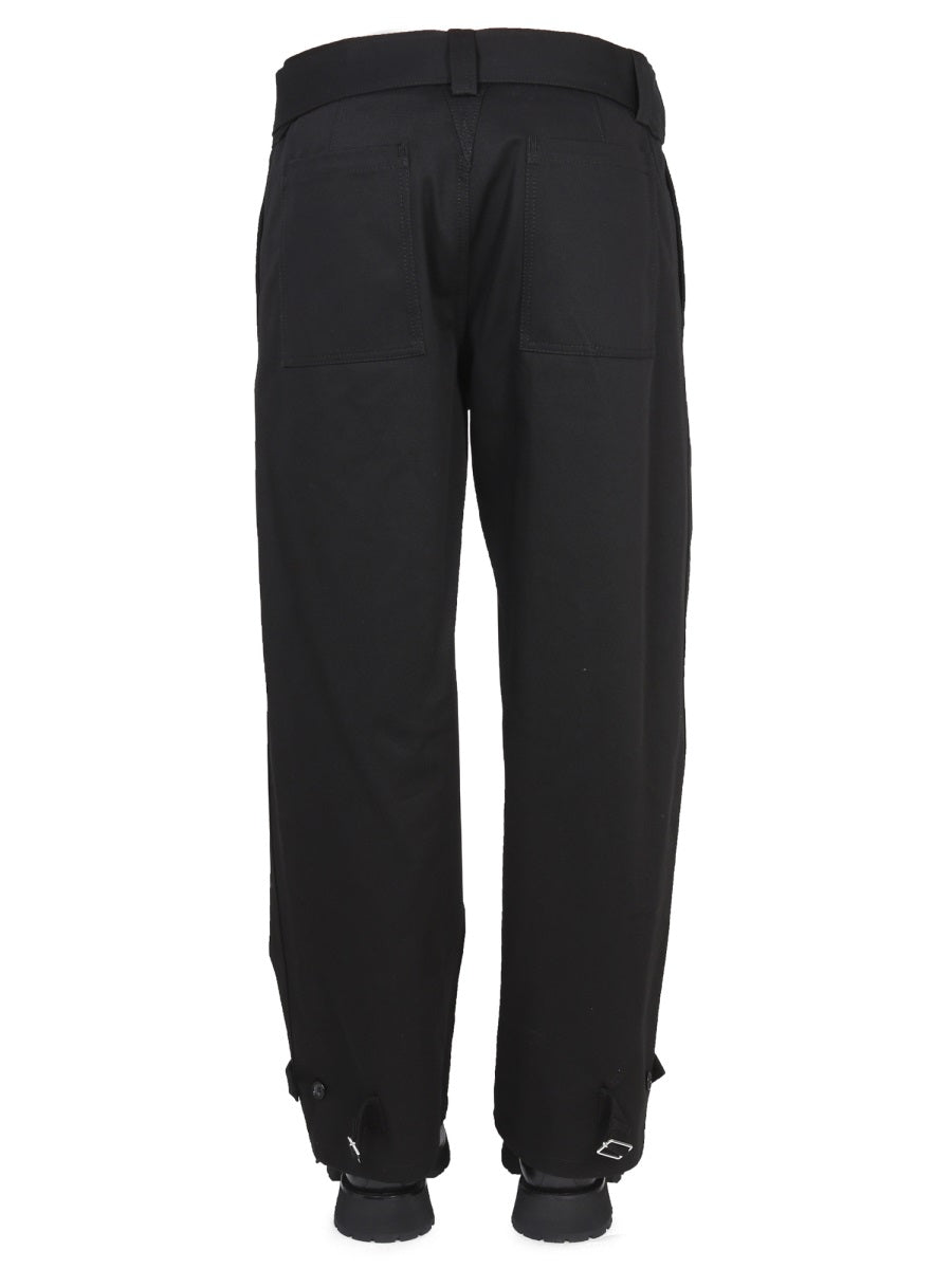 Close-up of Alexander McQueen pants hardware and fine stitching
