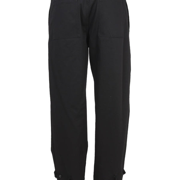 Close-up of Alexander McQueen pants hardware and fine stitching