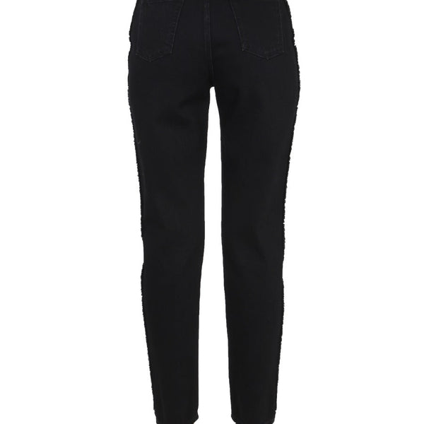 Close-up of Alexander McQueen pants hardware and fine stitching