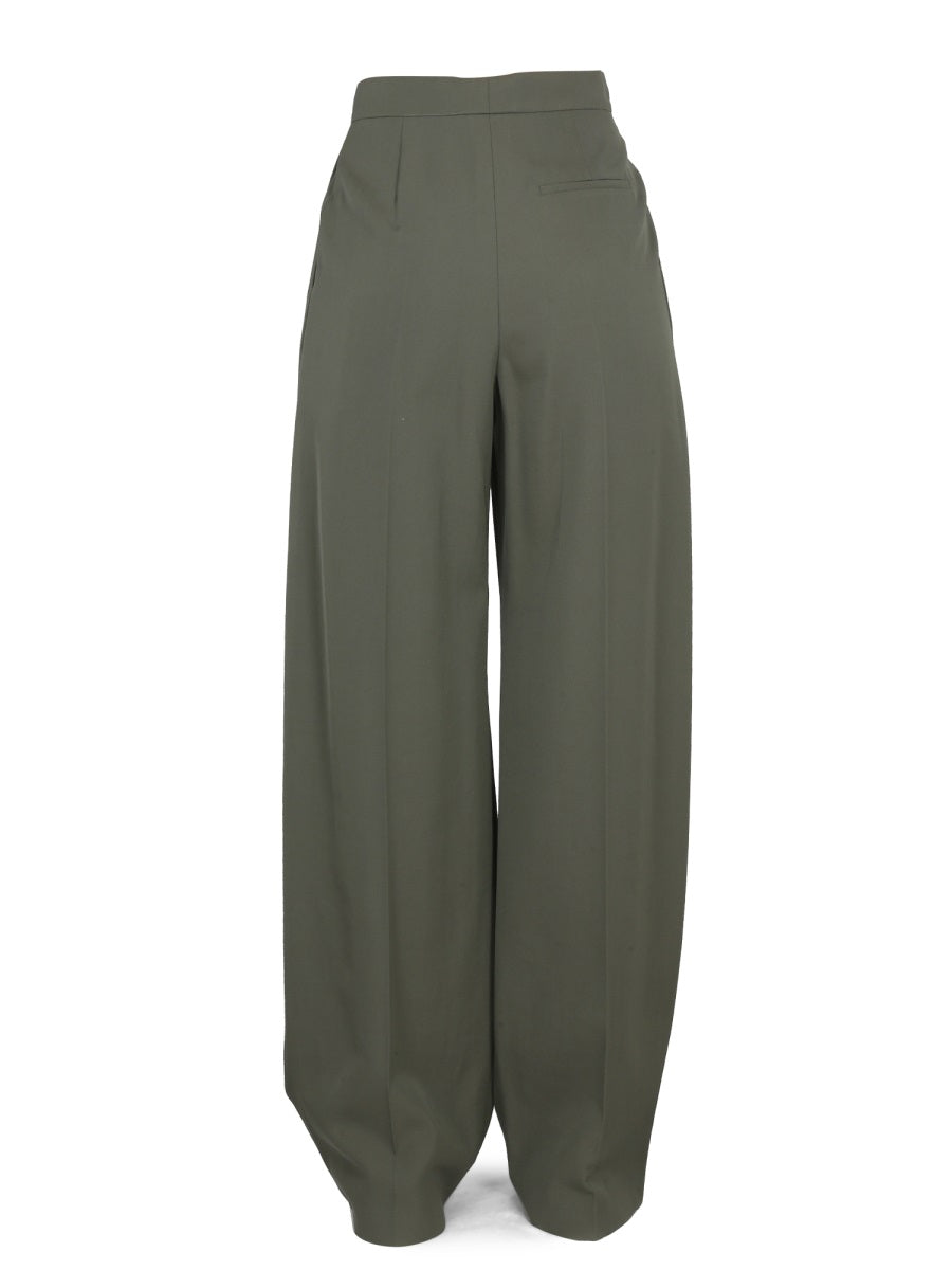 Close-up of Alexander McQueen pants hardware and fine stitching
