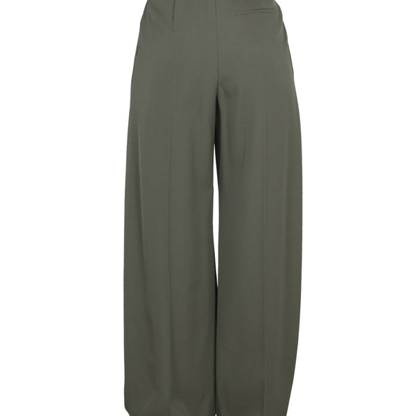Close-up of Alexander McQueen pants hardware and fine stitching