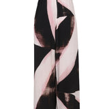 Close-up of Alexander McQueen pants hardware and fine stitching