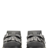 Close-up of Alexander McQueen slides hardware and fine stitching
