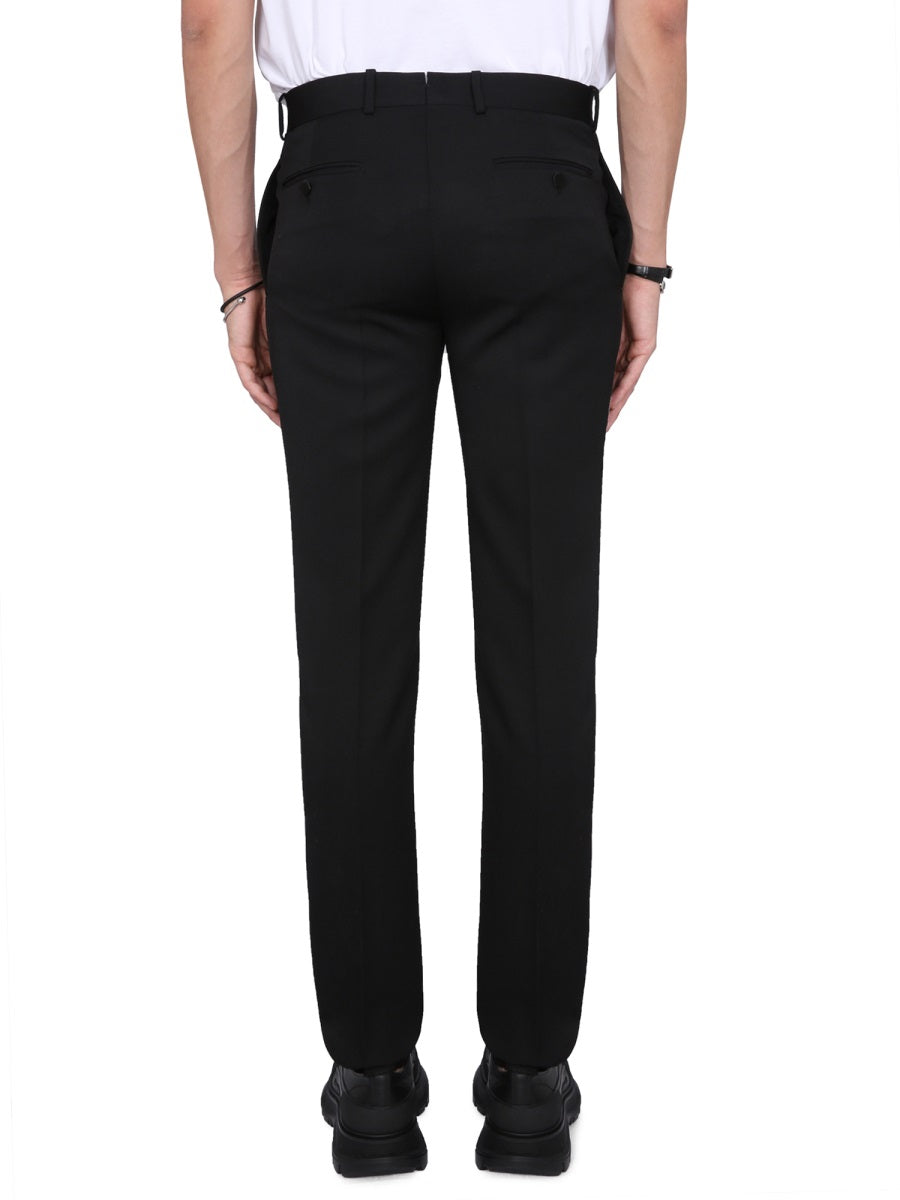 Close-up of Alexander McQueen pants hardware and fine stitching