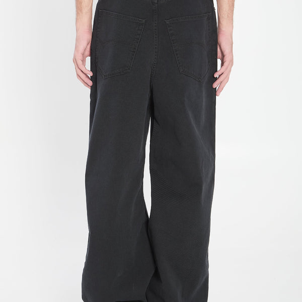 Close-up of Balenciaga pants hardware and fine stitching