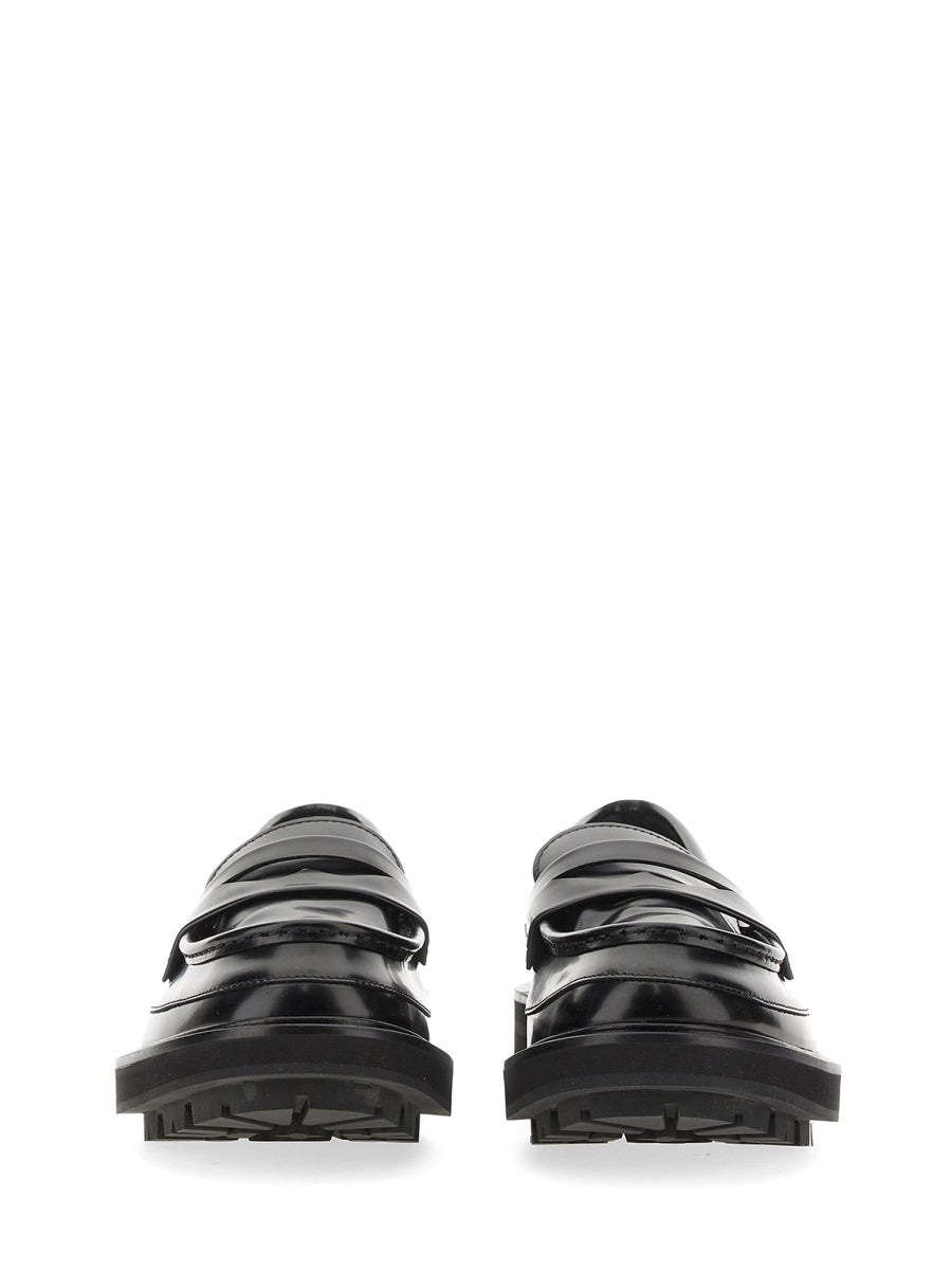 Close-up of Alexander McQueen slides hardware and fine stitching