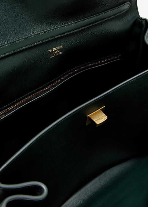 Close-up of Balenciaga handbags hardware and fine stitching