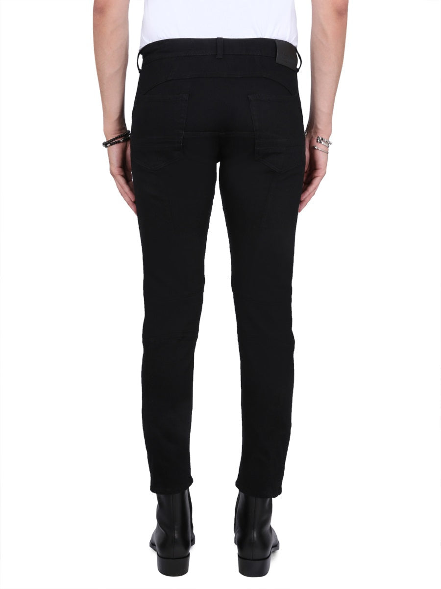Close-up of Alexander McQueen pants hardware and fine stitching