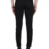 Close-up of Alexander McQueen pants hardware and fine stitching