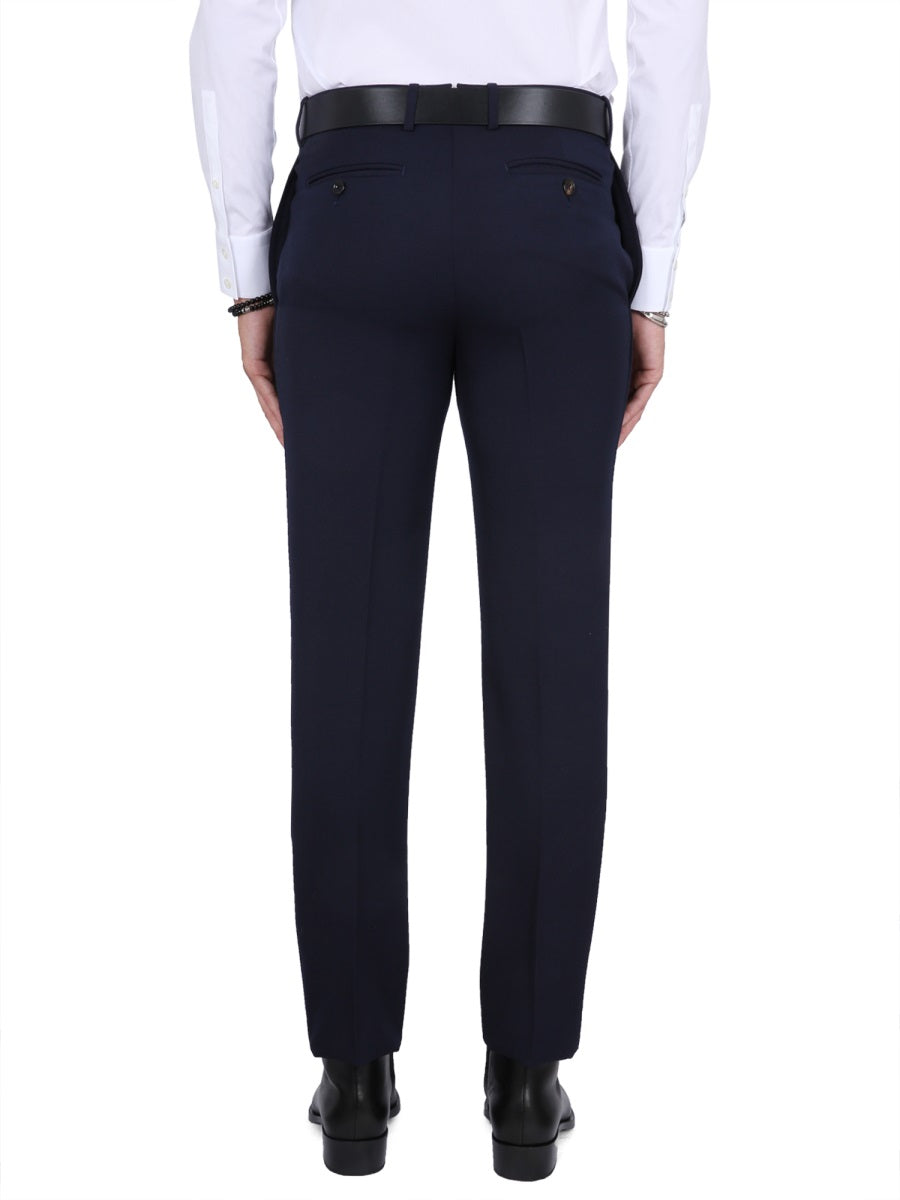 Close-up of Alexander McQueen pants hardware and fine stitching