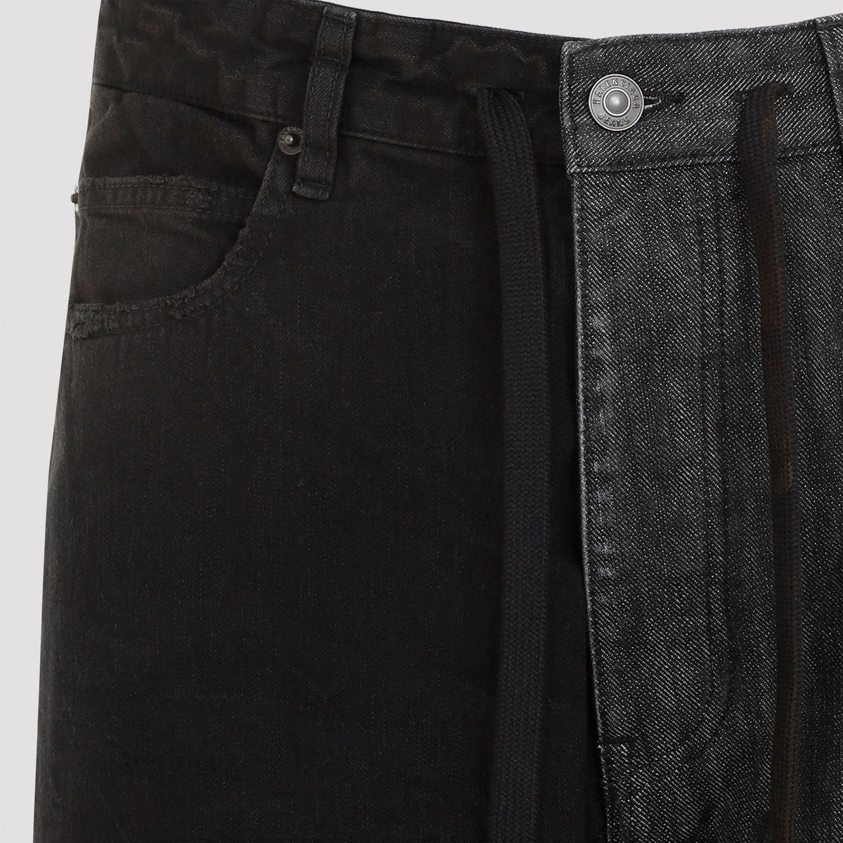 Close-up of Balenciaga pants hardware and fine stitching
